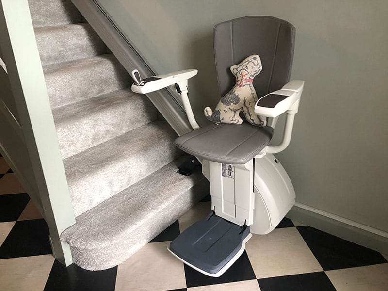 stairlift from Only Lifts resting at the bottom of the stairs