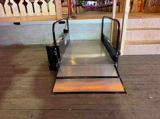 Wheelchair platform lift at an entrance